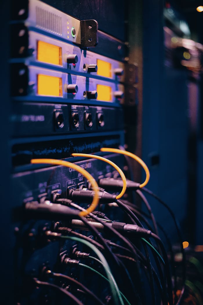 Close-up of network cables and ports in a server rack, showcasing connectivity.