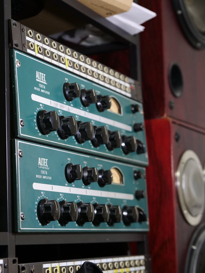 Close-up of a classic analog audio mixing equipment with dials and knobs in a studio.