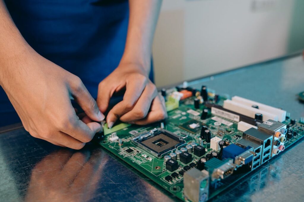 Hands-on assembly of a computer motherboard with precision tools.